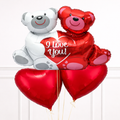 Two balloon bears, one red and one white with a heart, on a white background