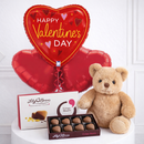 Valentine's Day gift set with heart-shaped balloon, teddy bear, and chocolate box on a white surface.